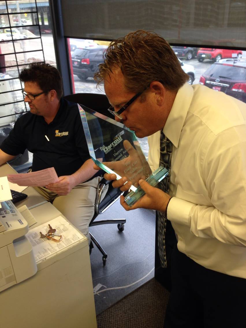 Gary Woodward being presented with a dealership sales award
