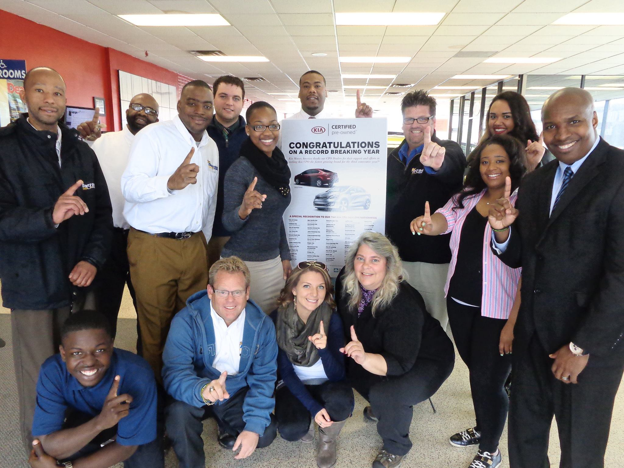 Used car and dealership team celebrating a record breaking year